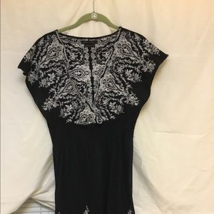 Dress black with white embroidery.
